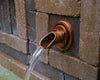Atlantic Water Gardens Copper Finish Ravenna Wall Spout set within patio hardscape