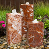 Marble-like water fountain with decorative stones.