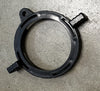 Black plastic ring with two clips on a concrete surface