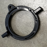 Black plastic ring with two clips on a concrete surface