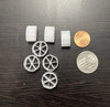 Wagon Wheel shaped media for pressure filter. Displayed next to a penny and a quarter for size reference.