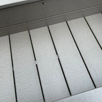 Close-up of the inside of a gray poly planter box with horizontal slats