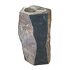 A freestanding stone pedestal fountain with a hexagonal top and a central basin, featuring a split stone facade in dark charcoal and earthy brown tones, isolated on a white background.