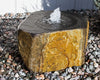 Stone fountain with water feature on a pebble ground
