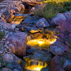 Beautifully illuminated pond and waterfall.