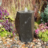 Alternating Rough & Polished sides for water to dance over the edge and down the natural, textured, surfaces. Real Stone Water Feature With A Zen Feel. In a garden bed of Mixed Colored Pebbles.