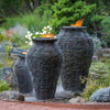 Aquascape®  Stacked Slate Fountain Urns creating beautiful water and fire display
