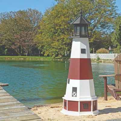 Octagonal Amish-Made Poly Montauk, NY Replica Lighthouse on the edge of a lake next to a pier