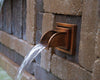 Atlantic Water Gardens Copper Finish Mantova Wall Spout set within patio hardscape
